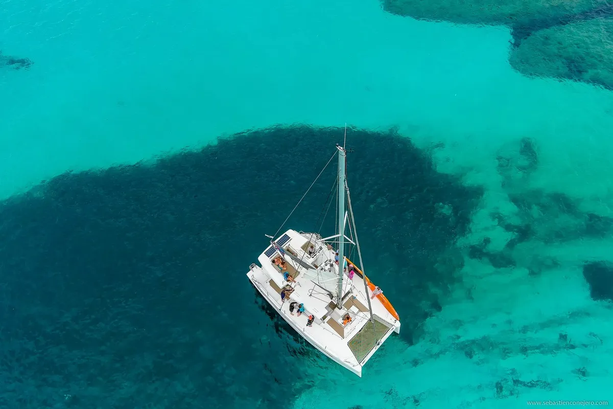 Luxury catamaran cruise along the Athens Riviera with guests relaxing and swimming